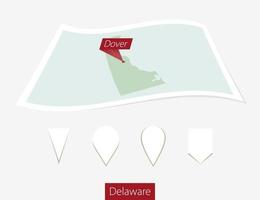 Curved paper map of Delaware state with capital Dover on Gray Background. Four different Map pin set. vector