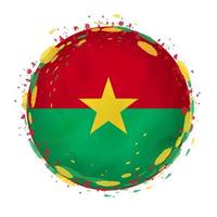 Round grunge flag of Burkina Faso with splashes in flag color. vector