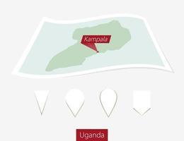 curvo papel mapa de Uganda con capital Kampala en gris antecedentes. cuatro diferente mapa alfiler colocar. vector