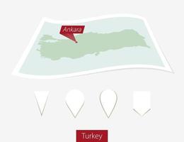 Curved paper map of Turkey with capital Ankara on Gray Background. Four different Map pin set. vector