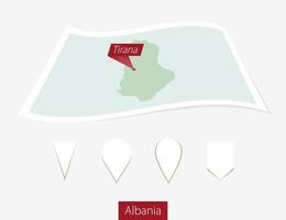 Curved paper map of Albania with capital Tirana on Gray Background. Four different Map pin set. vector