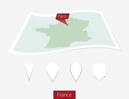 Curved paper map of France with capital Paris on Gray Background. Four different Map pin set. vector