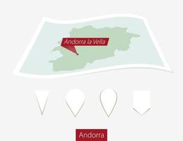 Curved paper map of Andorra with capital Andorra la Vella on Gray Background. Four different Map pin set. vector