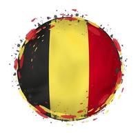 Round grunge flag of Belgium with splashes in flag color. vector