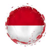 Round grunge flag of Indonesia with splashes in flag color. vector