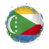 Round grunge flag of Comoros with splashes in flag color. vector