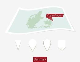 curvo papel mapa de Dinamarca con capital Copenhague en gris antecedentes. cuatro diferente mapa alfiler colocar. vector