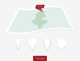 Curved paper map of Tunisia with capital Tunis on Gray Background. Four different Map pin set. vector