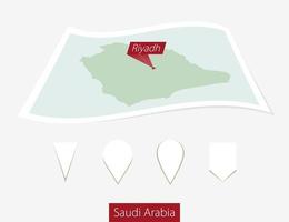 Curved paper map of Saudi Arabia with capital Riyadh on Gray Background. Four different Map pin set. vector