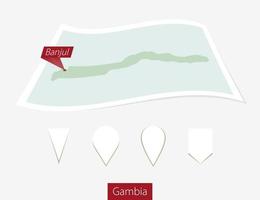 Curved paper map of Gambia with capital Banjul on Gray Background. Four different Map pin set. vector