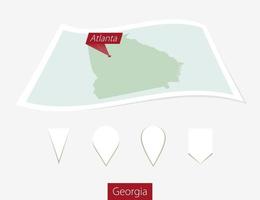 Curved paper map of Georgia state with capital Atlanta on Gray Background. Four different Map pin set. vector