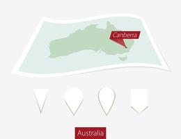 Curved paper map of Australia with capital Canberra on Gray Background. Four different Map pin set. vector