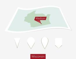 Curved paper map of Wisconsin state with capital Madison on Gray Background. Four different Map pin set. vector