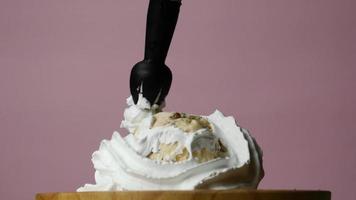 Front view of white whipped cream slowly squeezed into cup. video