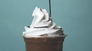 Close-up view of chocolate sauce poured over juicy whipped cream. video