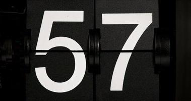 Vintage flip clock countdown 57 white numbers change to 58. video