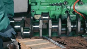 Truck engine repair. Motorists install the crankshaft in the engine. video