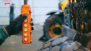 A man presses a button on a control panel in a factory. Work in production. Control of the lifting crane video