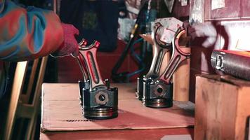 A Car Repairman Puts Car Engine Pistons On The Table. video