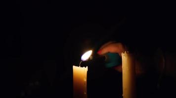 Middle age woman lighting the candles with lighter after wind blows off video