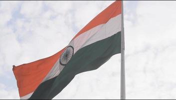 India flag flying high at Connaught Place with pride in blue sky, India flag fluttering, Indian Flag on Independence Day and Republic Day of India, tilt up shot, Waving Indian flag, Har Ghar Tiranga video