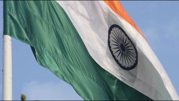 India flag flying high at Connaught Place with pride in blue sky, India flag fluttering, Indian Flag on Independence Day and Republic Day of India, tilt up shot, Waving Indian flag, Har Ghar Tiranga video