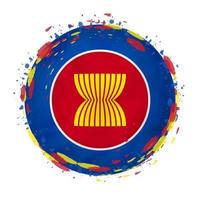 Round grunge flag of ASEAN with splashes in flag color. vector