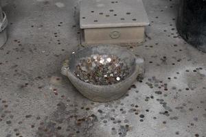 pompei ruins houses full of tourist coins photo