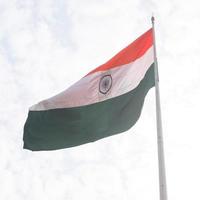 India flag flying high at Connaught Place with pride in blue sky, India flag fluttering, Indian Flag on Independence Day and Republic Day of India, tilt up shot, Waving Indian flag, Har Ghar Tiranga photo