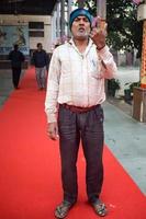 New Delhi, India - December 04 2022 - Unidentified people showing their ink-marked fingers after casting votes in front of polling booth of east Delhi area for MCD local body Elections 2022 photo