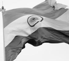 India flag flying high at Connaught Place with pride in blue sky, India flag fluttering, Indian Flag on Independence Day and Republic Day of India, tilt up shot, Waving Indian flag, Har Ghar Tiranga photo