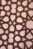 Silhouette of laser cut template panel with orange light. Arabian ornamental panel set. Silhouette or backlight ornament for background. photo