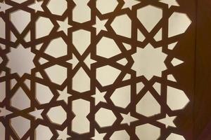 Silhouette of laser cut template panel with brown light. Arabian ornamental panel set. Silhouette or backlight ornament for background. photo