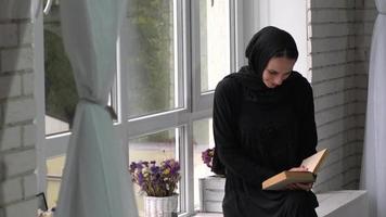 Muslim arabic female reading book at home. video