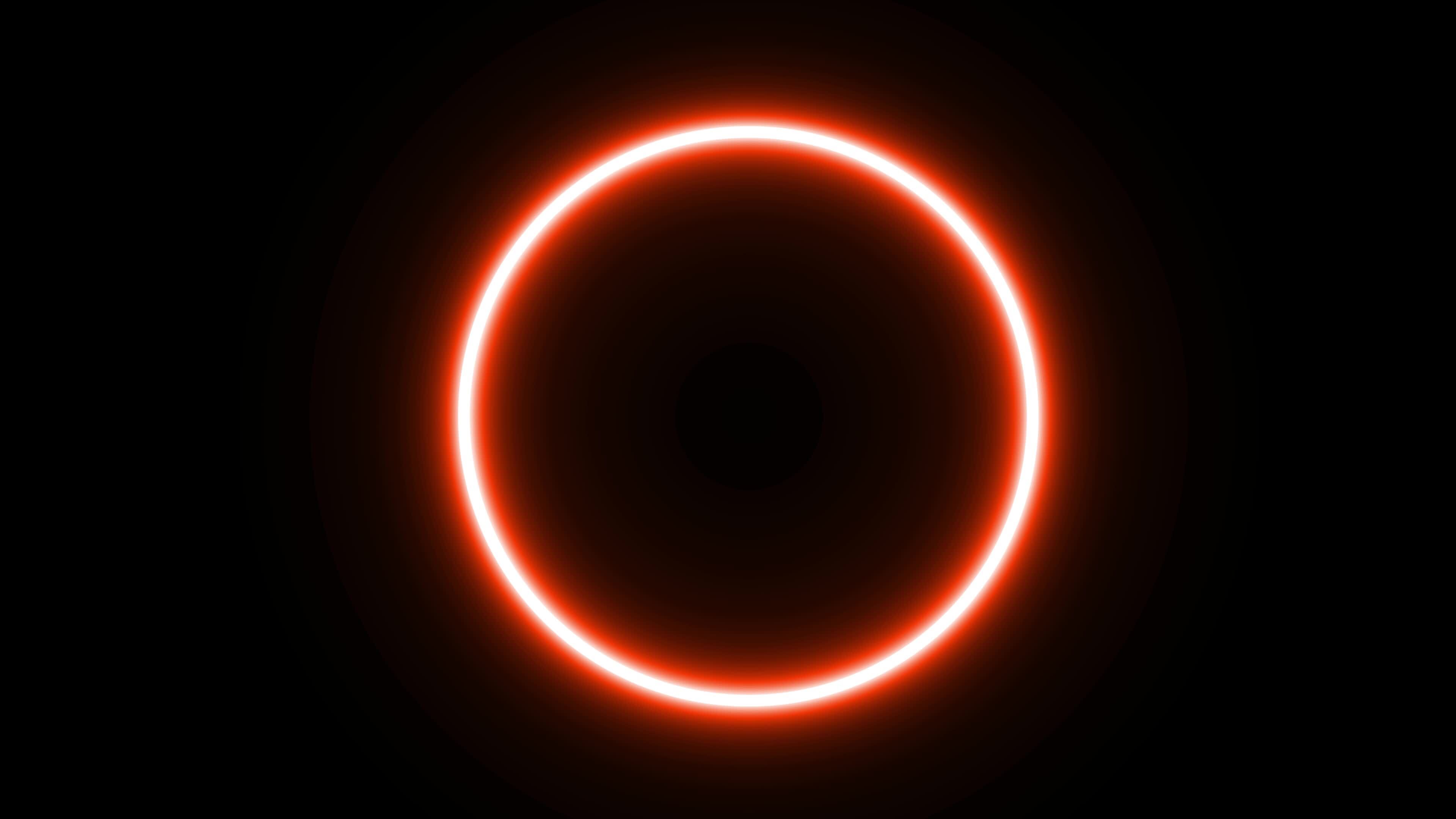 Animated orange slowly flashing neon circle on black background