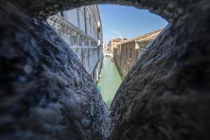 view from interior passage of Venice bridge of sighs photo