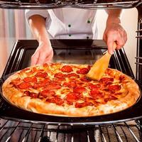 classic pizza man with hand cheese on the table in a cafe on a wooden stand with a cut triangular piece and a pizza knife photo