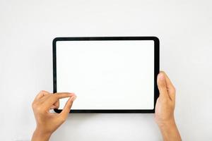 Hand holding and pinch tablet horizontally for mockups photo