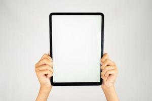 Two hands holding blank screen tablet for mockups photo
