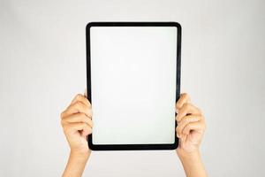 Two hands holding blank screen tablet for mockups photo