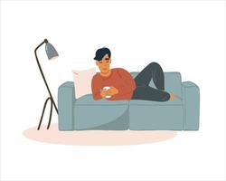 A man or a boy lies on the couch and looks into the smartphone. vector