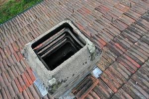 italiy tile roof chimney detail drone view photo