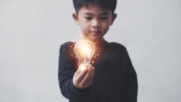 Four year old boy holding light bulbs, Innovation. Hands holding light bulb for Concept new idea concept with innovation and inspiration, innovative technology in science and communication concept, photo