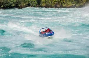 Taupo, New Zealand - April 26 2017 - Tourist adventure in Huka Falls with Huka jet boat the most famous iconic thriller activity in Taupo, New Zealand. photo