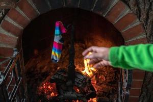 traditional epiphany stocking set up holding on fireplace photo