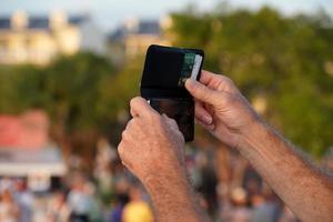 Hands taking selfie with smartphone at sunset in key west photo