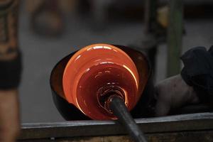 glass master while working in Murano furnace glass factory Venice Italy photo