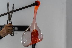 glass master while working in Murano furnace glass factory Venice Italy photo