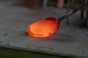 glass master while working in Murano furnace glass factory Venice Italy photo