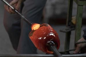 glass master while working in Murano furnace glass factory Venice Italy photo